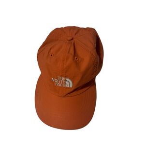 The north face bright orange hat with white accents in great condition, one size